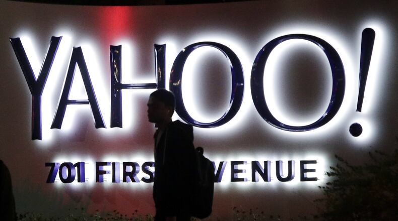 In this Nov. 5, 2014, file photo, a person walks in front of a Yahoo sign at the company’s headquarters in Sunnyvale, Calif. (AP Photo/Marcio Jose Sanchez, File)