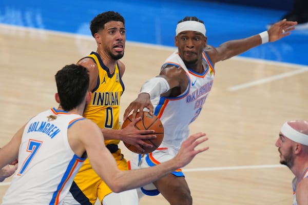 Oklahoma City Thunder guard Shai Gilgeous-Alexander (2) defends against Indiana Pacers guard Tyrese Haliburton (0) during the first half of Game 1 of the NBA Finals basketball series Thursday, June 5, 2025, in Oklahoma City. (AP Photo/Nate Billings)
