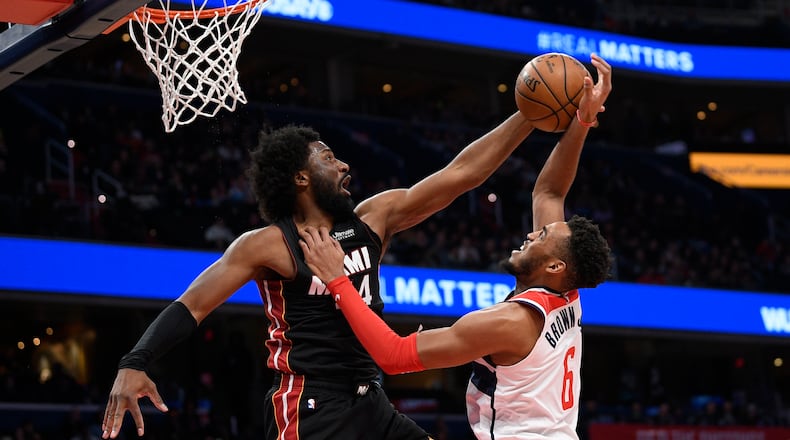 Miami forward Solomon Hill (44) blocks Washington forward Troy Brown Jr. (6) during the second half Sunday, March 8, 2020, in Washington. (Nick Wass/AP)