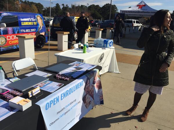 Viviana Cossio stands beside the information table she set up in Lilburn to draw people to inquire about enrolling in health care plans under Obamacare in November. (PHOTO by Ariel Hart/AJC)