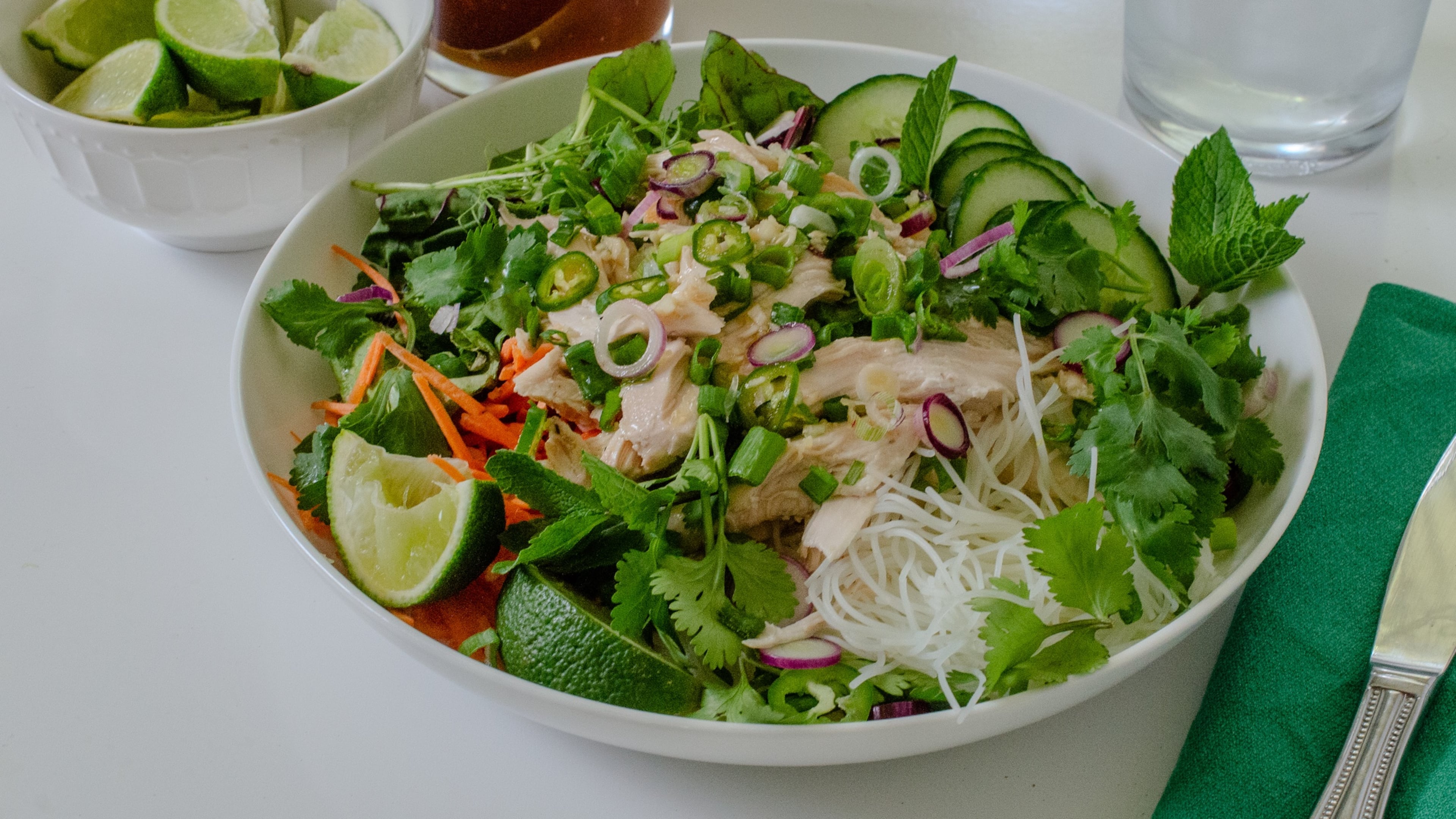 Served with nuoc cham, an umami-packed lime dressing, this Vietnamese noodle bowl is filling and refreshing, made with crunchy vegetables, tender rotisserie chicken and chewy rice noodles. (Virginia Willis for the AJC)