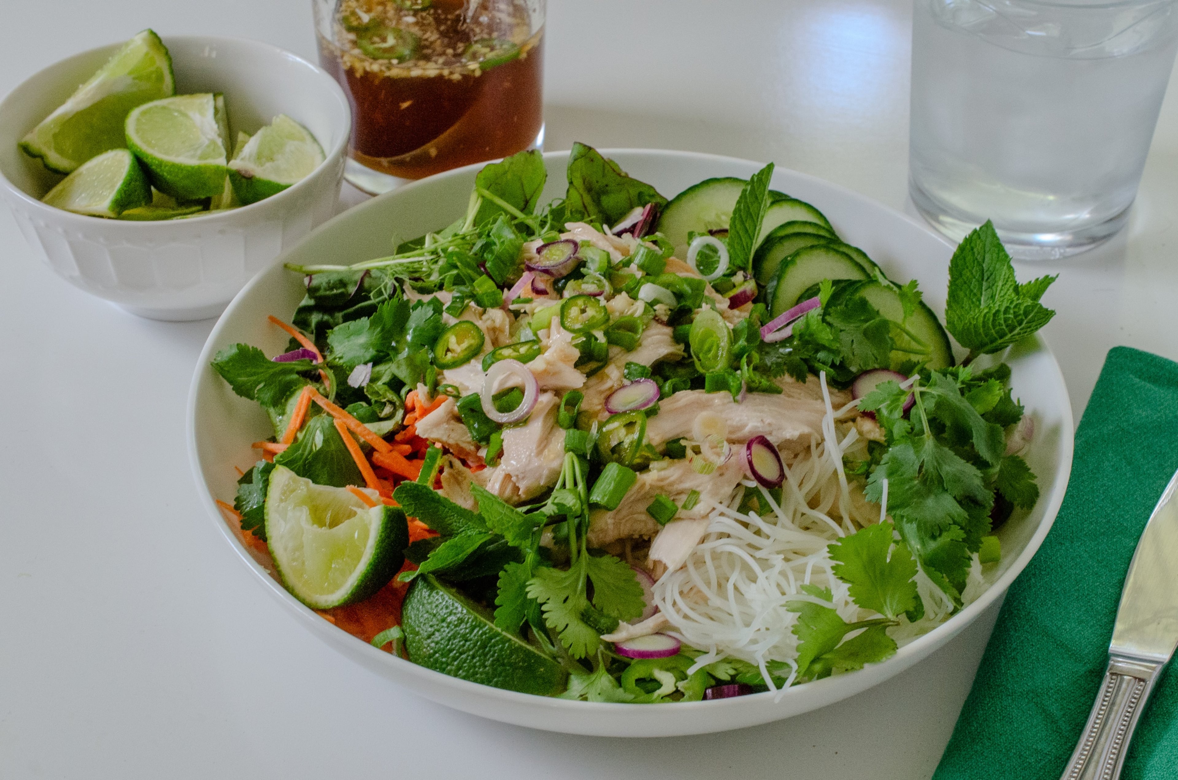 Served with nuoc cham, an umami-packed lime dressing, this Vietnamese noodle bowl is filling and refreshing, made with crunchy vegetables, tender rotisserie chicken and chewy rice noodles. (Virginia Willis for the AJC)