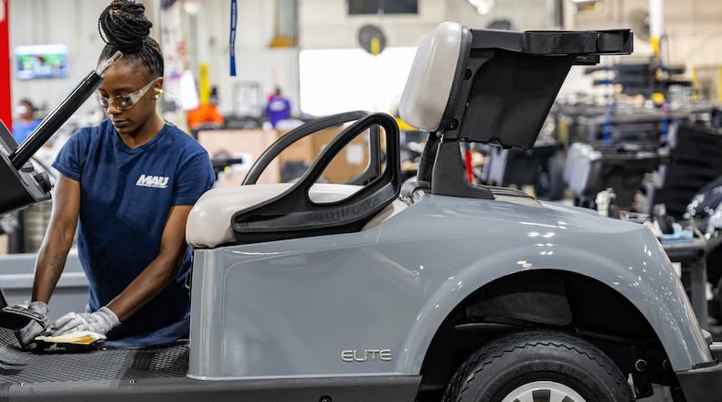 Worker at Textron Specialized Vehicles making a golf cart on assembly line in Augusta.