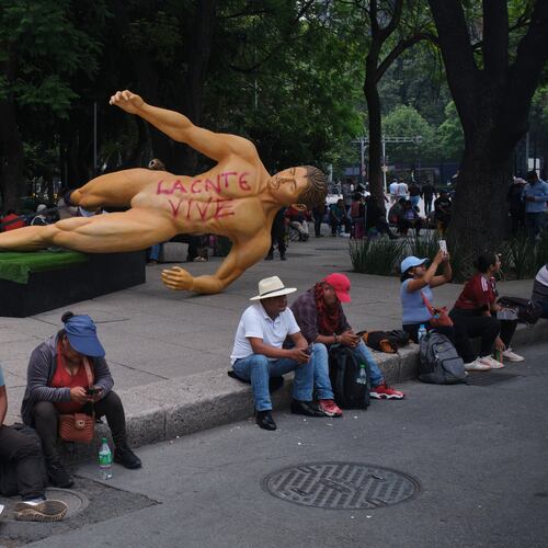 A World Cup statue, with graffiti that reads in Spanish, "The National Educational Workers Coordination lives" lies sideways during a teachers' protest for higher salaries sit in Mexico City, Tuesday, June 2, 2026. (AP Photo/Jon Orbach)