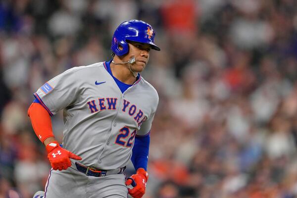 New York Mets' Juan Soto runs up the first base line after hitting a single against the Houston Astros during the first inning of an opening-day baseball game Thursday, March 27, 2025, in Houston. (AP Photo/David J. Phillip)