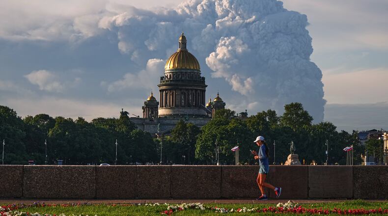 Smoke billows into the sky following Ukrainian drone strikes on warehouses of Russia's online retailer Wildberries, in St. Petersburg, Russia, Friday, July 24, 2026, with St. Isaac's Cathedral seen in foreground. (UGC via AP)