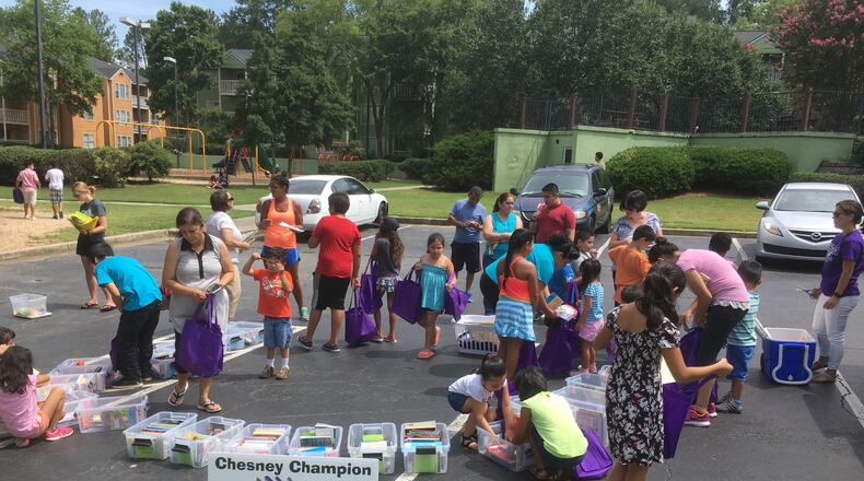Students and parents from Chesney Elementary pick their reading selections from the Chesney Champion Bookmobile, now in its second year.
