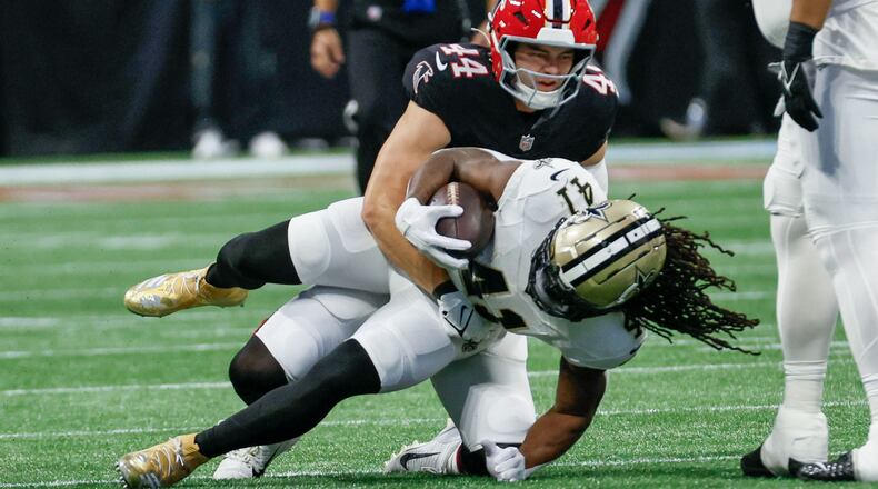 Atlanta Falcons linebacker Troy Andersen (44) stops New Orleans Saints running back Alvin Kamara (41) during the first half of an NFL football game against the New Orleans Saints on Sunday, Sept. 29, at Mercedes-Benz Stadium in Atlanta.
(Miguel Martinez/ AJC)