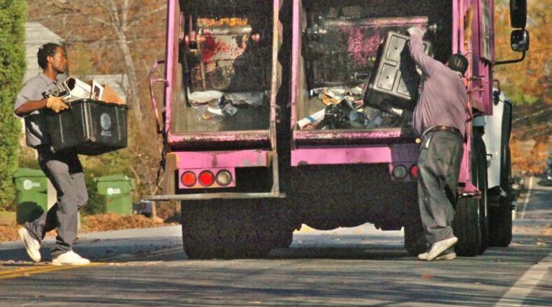 Sanitation workers pick up recyclable materials in Atlanta’s Candler Park/Inman Park area. Atlanta-based waste disposal technology firm Rubicon is helping the city gauge the impact of its recycling efforts with new mobile technology that collects varioius data on recyling while garbage trucks are on their routes. AJC File Photo