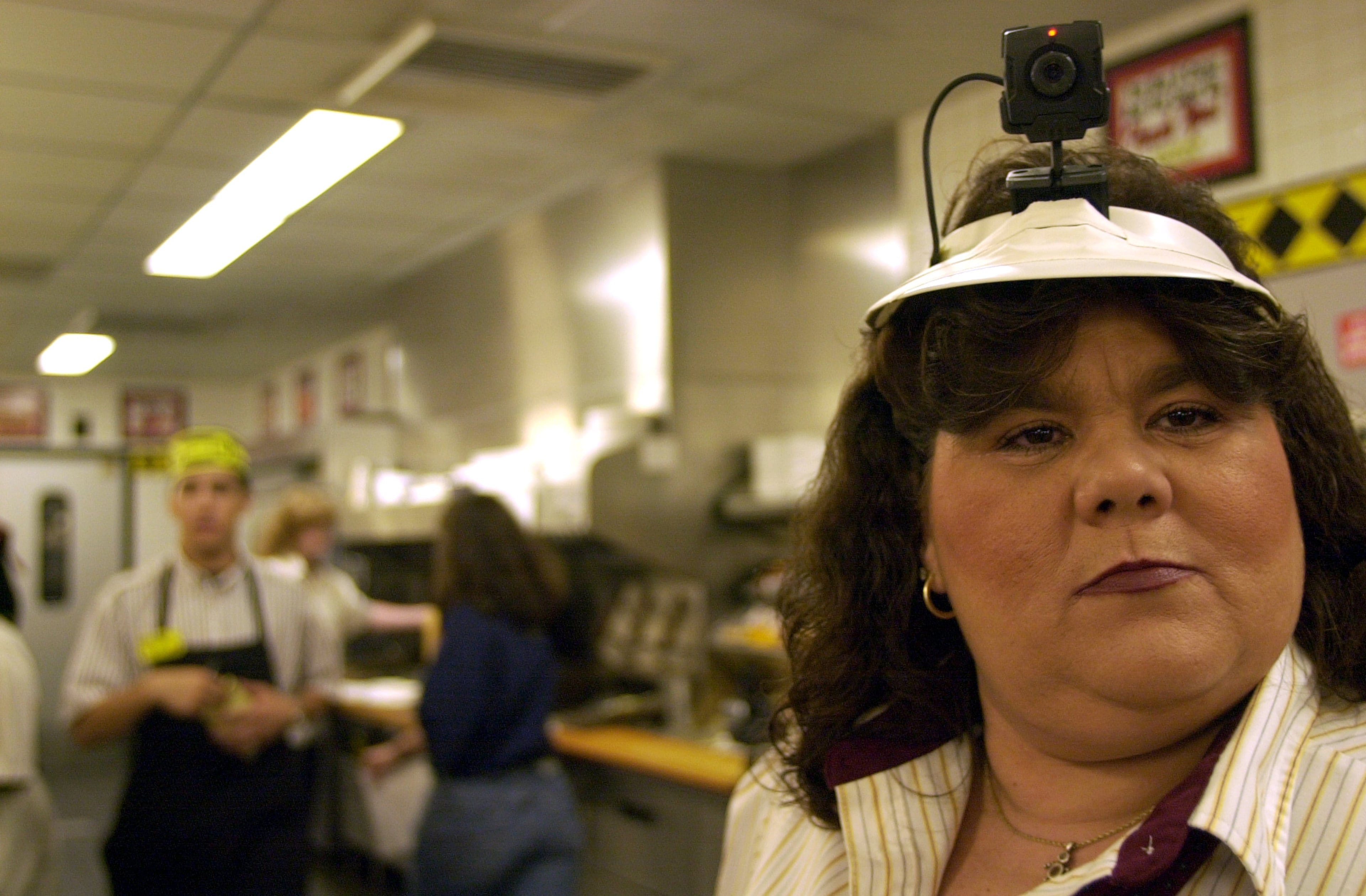 2000: Angie Shepard, senior third-shift waitress at a Rockdale Waffle House, wears a 'waitress cam' on her visor while waiting to begin the filming of Waffle House Live, a TV show pilot thought up by Pat Crosby.