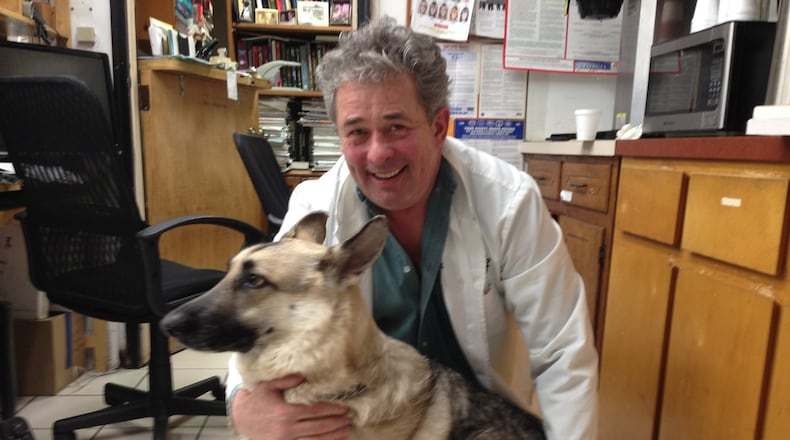 Dr. Michael Good hangs out with one of his rescue dogs, a German shepherd named Phillip. Good, owner of Town & Country Veterinary Clinic in Marietta, is founder of the nonprofit Homeless Pets Foundation and Homeless Pet Clubs of America. GRACIE BONDS STAPLES / GSTAPLES@AJC.COM