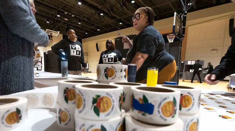 Poll manager Rosland Sneed gets her team ready at the Don And Mary Ellen Harp Student Center located at 3209 Mathieson Place NE in Atlanta on Tuesday. (John Spink/AJC)