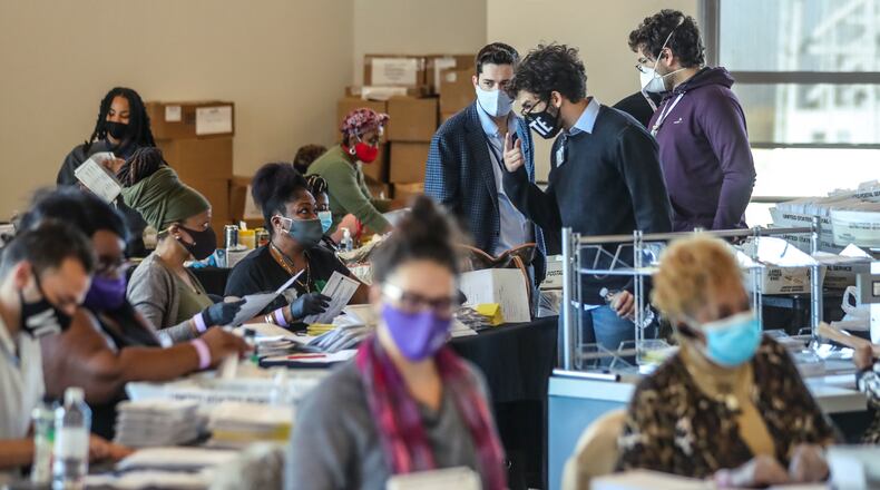 November 5, 2020 Atlanta: Fulton County election workers were hard at it again on Thursday, Nov. 5, 2020 counting ballots at State Farm Arena. Fulton County officials say election workers have completed processing absentee-by-mail ballots. Fulton elections head Richard Barron said that 145,748 absentee-by-mail ballots have been processed. Of that, he said, results of 138,000 have been posted online and 1,200 more absentees that required more signature verification will come later today — meaning there’s a difference of roughly 7,000 between what’s been processed and what’s been posted. There are still 3,600 provisional ballots and an undetermined amount of military overseas ballots left to be finalized. The deadline for those is 5 p.m. Friday. (John Spink / John.Spink@ajc.com)