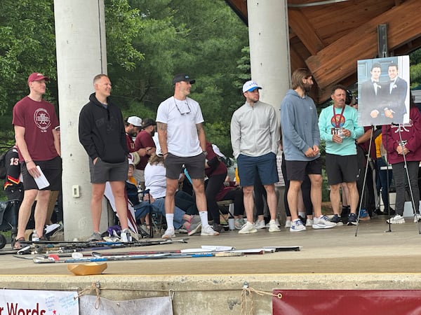 Hockey players, from left, Buddy Robinson, Brady Tkachuk, Erik Gudbranson, Tony DeAngelo and Zach Aston-Reese along with Guy Gaudreau, father of hockey players Johnny and Matthew Gaudreau who were fatally struck by a motorist while riding bicycles, attend the inaugural Gaudreau Family 5K Walk, Run and Family Day, Saturday, May 31, 2025, in Sewell, N.J. (AP Photo/Stephen Whyno)