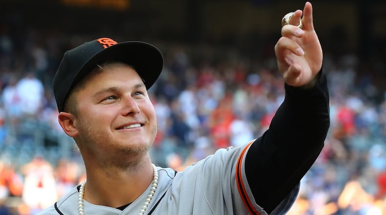Former Braves outfielder Joc Pederson is presented his World Series ring, admiring it proudly while showing it off to Braves fans, before the Giants played the Braves on Monday in Atlanta. (Curtis Compton / Curtis.Compton@ajc.com)