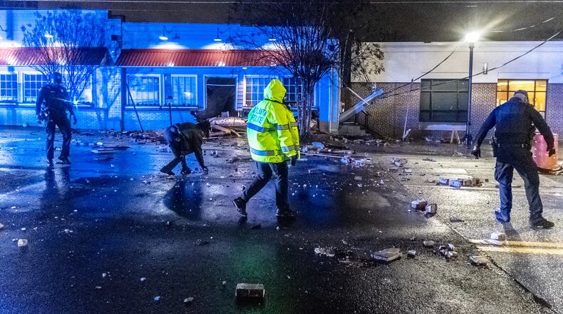 Atlanta police officers threw rocks and debris out of the roadway along Ponce de Leon to make a clearing for traffic after the roof of Mary Mac’s Tea Room in Midtown Atlanta partially collapsed overnight Wednesday, March 6, 2024. A public information officer for the Atlanta Police Department told The Atlanta Journal-Constitution that firefighters responded to the restaurant at 224 Ponce De Leon Ave. NE just before 4 a.m. They found a pole down atop the partially collapsed roof and debris in the roadway. There were no injuries. The westbound lanes were briefly blocked due to debris between Myrtle Street and Penn Avenue. By 6:30 a.m. all lanes had reopened, according to Channel 2 Action News. Bricks, insulation and other debris are still blocking the sidewalk in front of the restaurant. Atlanta police and utility crews were working to clean up debris from the road. At least one power line appears to have been brought down, and Georgia Power workers disconnected power to the restaurant until repairs can be made. The single-story Mary Mac’s building was built in 1915, according to Fulton County property records. The 0.8-acre site that houses the 13,278-square-foot restaurant was most recently assessed at $3.8 million. The iconic restaurant has been an Atlanta institution for over 75 years, serving made-from-scratch Southern comfort food, including fried chicken, country fried steak, meatloaf, collards, yeast rolls and macaroni and cheese. Open in 1945 as Mrs. Fuller’s Tea Room, the restaurant was purchased by Mary McKinsey in 1951, and she eventually changed the name to Mary Mac’s. (John Spink / John.Spink@ajc.com)