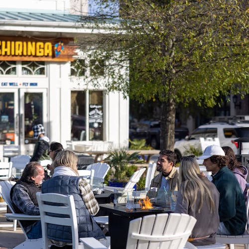People talking by fire infront of Chiringa in downtown Alpharetta on November 20, 2022