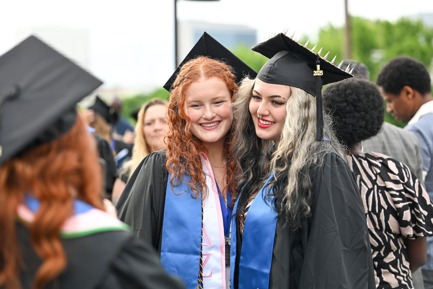 Haley Scott (left) poses for a photo with Chloe Wright after gradating during Georgia State University’s Spring commencement ceremony for the College of Arts & Sciences Wednesday, May 7, 2025 in Atlanta. (Daniel Varnado/For the Atlanta Journal-Constitution)