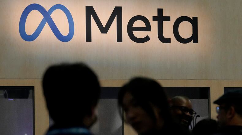 FILE - Attendees visit the Meta booth at the Game Developers Conference 2023 in San Francisco on March 22, 2023. (AP Photo/Jeff Chiu, File)