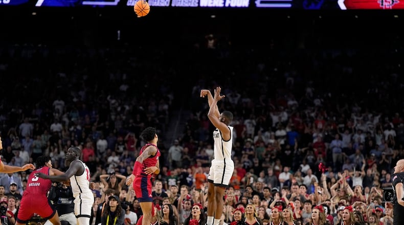 San Diego State guard Lamont Butler scores the game winning basket against Florida Atlantic in a Final Four college basketball game in the NCAA Tournament on Saturday, April 1, 2023, in Houston. (AP Photo/Brynn Anderson)