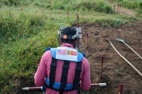A worker in protective gear works in a contaminated mining area in Mankulam, Sri Lanka, Thursday, April 3, 2025. (AP Photo/Eranga Jayawardena)
