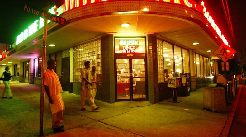 From 2003: One of the Majestic's cooks, Bernard Arnold, leans against a street sign as he takes a break from the graveyard shift at the diner. (Jenni Girtman/AJC staff)