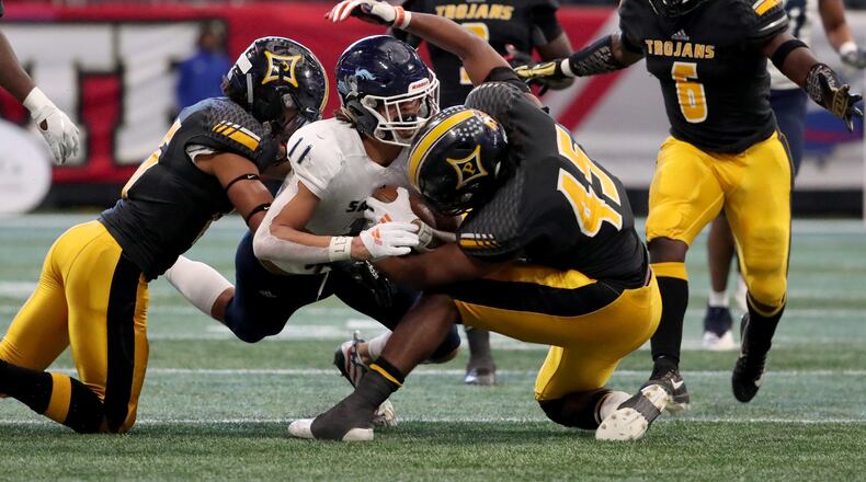 Cedar Grove wide receiver Jadon Haselwood (11) is tackled by Peach County Daelan Smith, left, and Sergio Allen (45) after a catch by Haselwood in the first half of the Class AAA State Championship at Mercedes-Benz Stadium, Tuesday, December 11, 2018, in Atlanta. (Jason Getz/Special to the AJC)