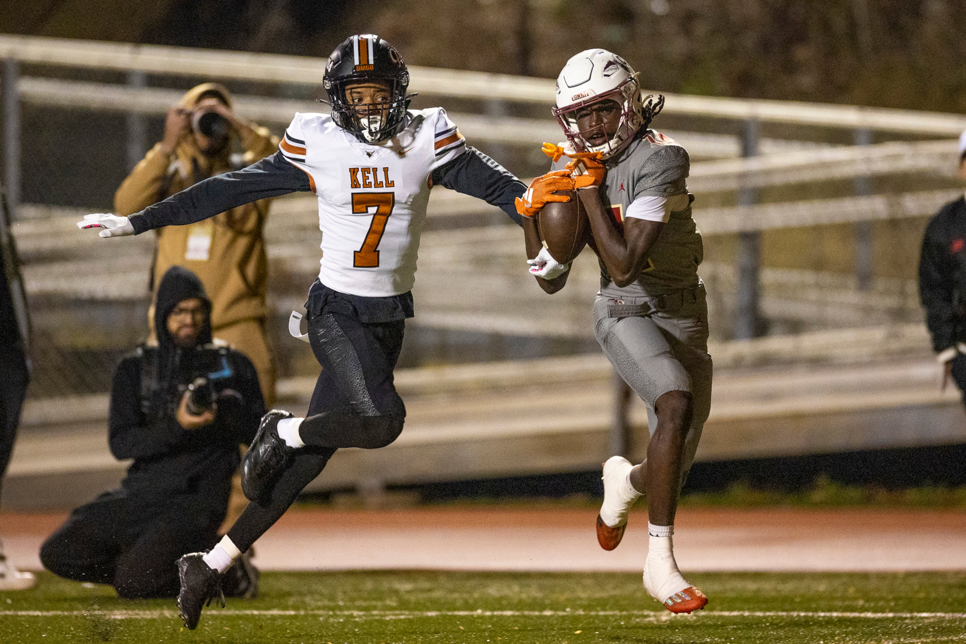 Creekside wide receiver Armani Hill (right) makes a catch while Kell defensive back Robert Tyson Jr. (left) tries to intercept during the first half of the class 4A semifinal against Kell at Creekside High School in Fairburn, GA on Friday, December 5, 2025. (Oscar Guevara Saenz for the AJC)