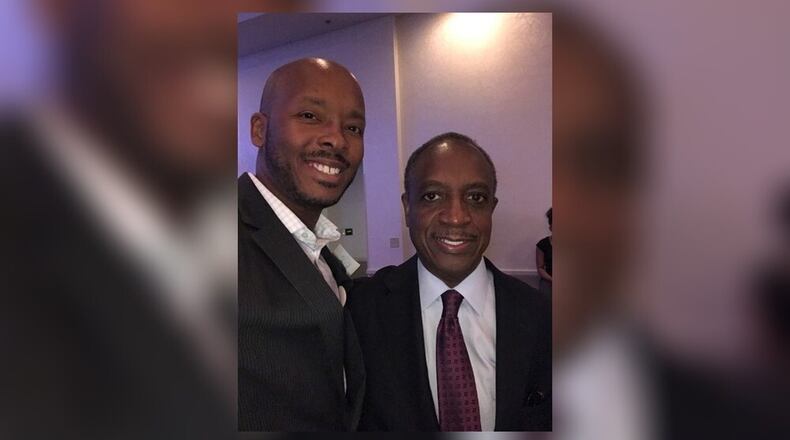 Kenneth Saunders III (left) with DeKalb County CEO Michael Thurmond. FAMILY PHOTO