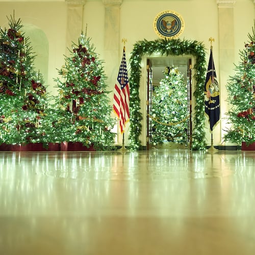 Christmas trees decorate the Cross Hall of the White House during a press preview of the Christmas decorations "Home is Where the Heart Is," Monday, Dec. 1, 2025, in Washington. (AP Photo/Evan Vucci)