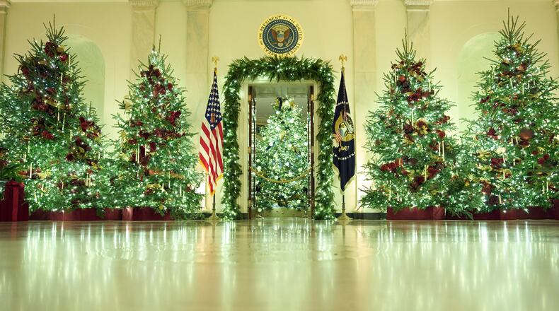 Christmas trees decorate the Cross Hall of the White House during a press preview of the Christmas decorations "Home is Where the Heart Is," Monday, Dec. 1, 2025, in Washington. (AP Photo/Evan Vucci)