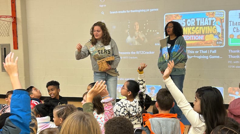 Lily Crick (left) and Gnouma Fofana talk about bullying with students at Livsey Elementary in Tucker.