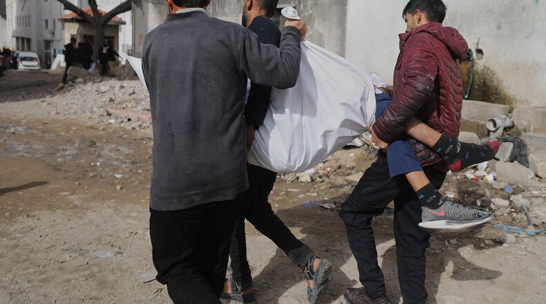 Palestinians carry the body of Mohammad Zawara, 15, who was killed in an Israeli strike, according to health officials, as they arrive at Shifa Hospital, Gaza City, Saturday, Jan. 24, 2026. (AP Photo/Yousef Al Zanoun)