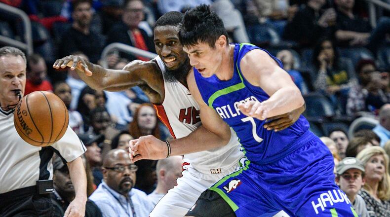 Miami Heat forward Okaro White and Atlanta Hawks forward Ersan Ilyasova (7), of Turkey, fight for the ball during the second half of an NBA basketball game, Friday, Feb. 24, 2017, in Atlanta. (AP Photo/John Amis)