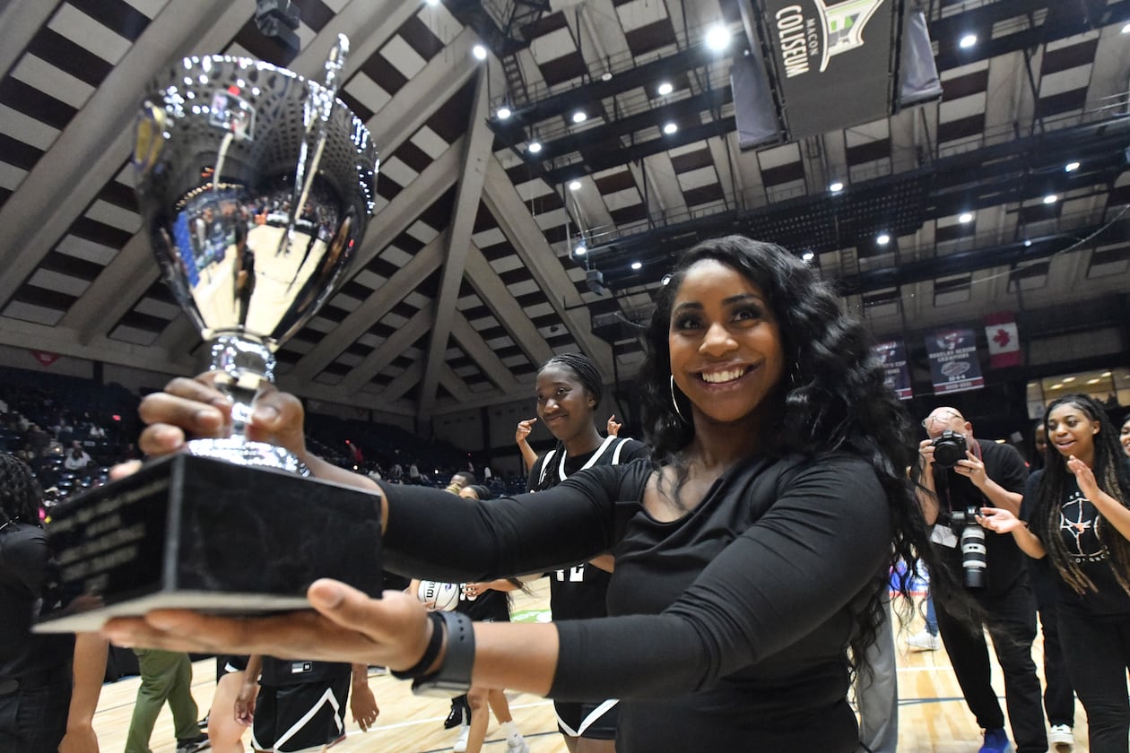 Kell head coach Kandra Bailey holds the championship trophy after her team's 57-36 victory over Warner Robins in the Class 5A girls state championship game in Macon, Thursday, March 9, 2023. (Hyosub Shin/AJC)