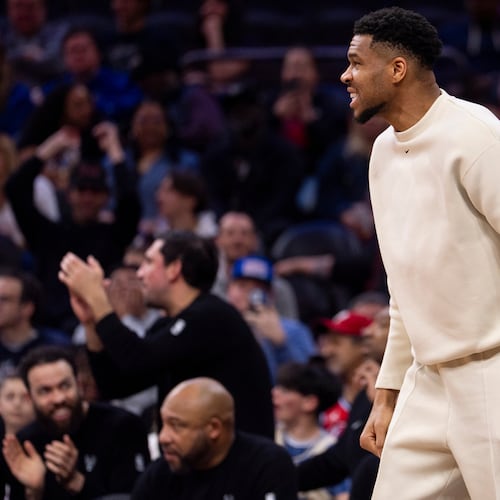 Milwaukee Bucks power forward Giannis Antetokounmpo, center, reacts from the sideline during the first half of an NBA basketball game against the Philadelphia 76ers, Sunday, April 12, 2026, in Philadelphia. (AP Photo/Chris Szagola)