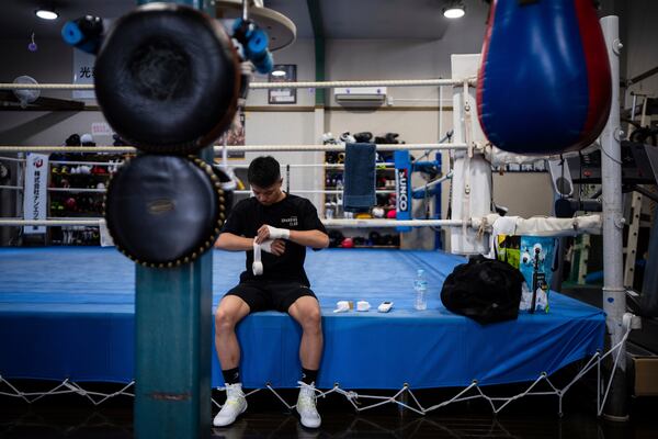 Junto Nakatani wraps his hands before a training session at a gym in Sagamihara City, Kanagawa Prefecture, Tuesday, July 1, 2025. (AP Photo/Louise Delmotte)
