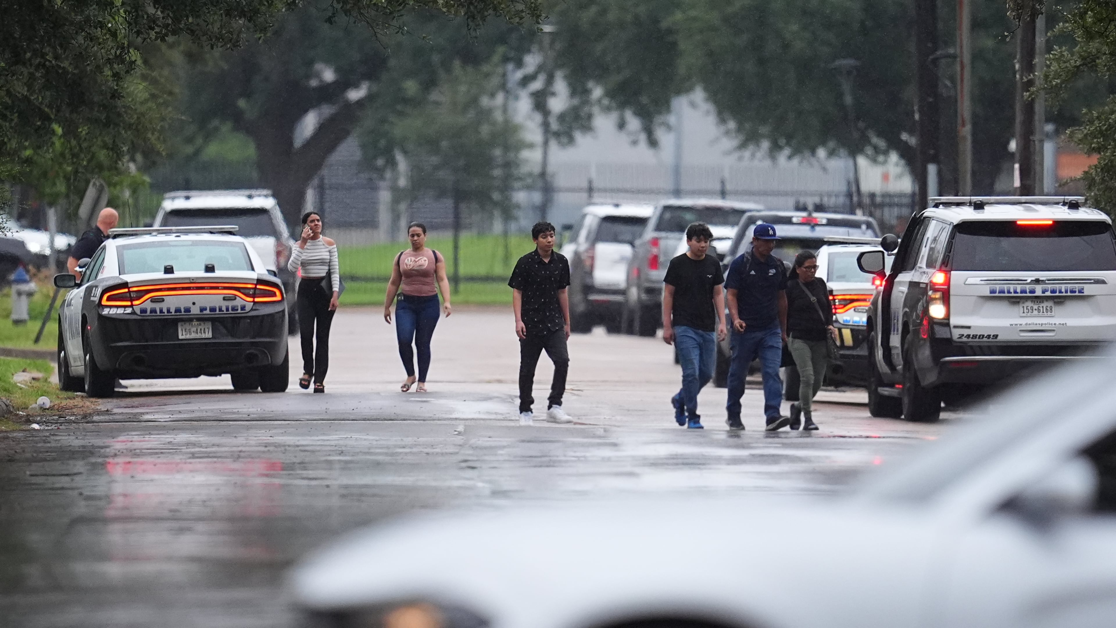 People who had appointments at a U.S. Immigration and Customs Enforcement office are turned away after a reported shooting in the facility in Dallas on Wednesday, Sept. 24, 2025. (AP Photo/Julio Cortez)