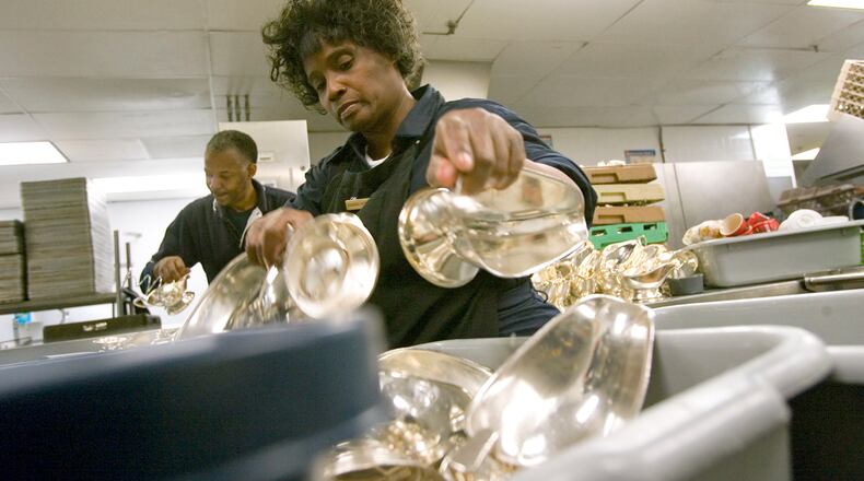 Barbara Jackson, the silver room attendant at the Ritz-Carlton, Buckhead, gathers items to be taken to the cleaning room on Wednesday night, Dec. 10, 2008. The mother of six grown children works the overnight shift, helping to ensure that thousands of silver items reflect the hotel's high standards. ALLEN SULLIVAN / aesullivan@ajc.com