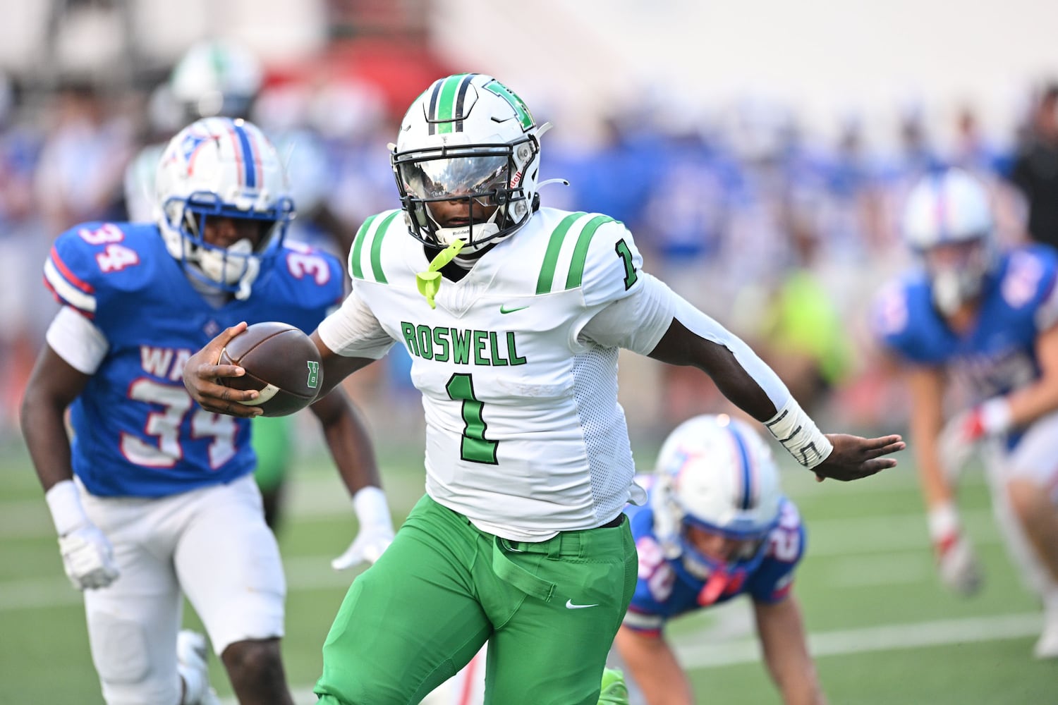 Roswell quarter back Trey Smith (1) carries the ball for a touchdown against Walton early in the first half his game Friday, August 29, 2025 at Walton High School. (Daniel Varnado/For the Atlanta Journal-Constitution)