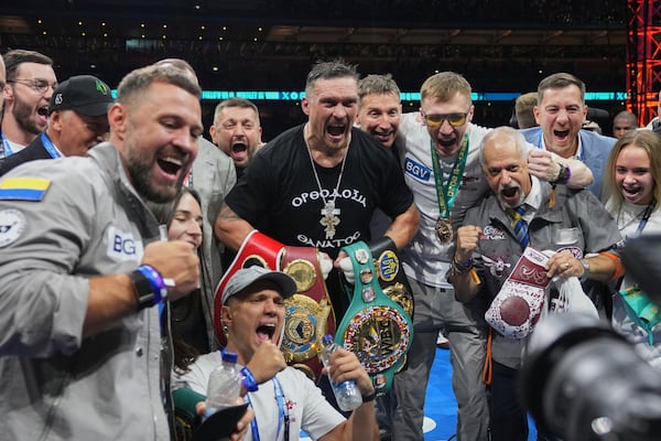 Ukraine's Oleksandr Usyk celebrates winning the undisputed world heavyweight boxing title fight against Britain's Daniel Dubois in London, Saturday, July 19, 2025. (AP Photo/Frank Augstein)