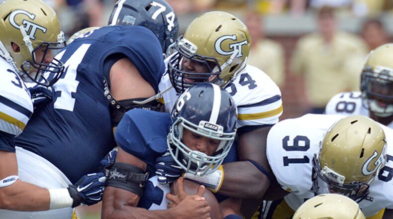 September 13, 2014 Atlanta - Georgia Southern Eagles running back Matt Breida (center) is brought down by Georgia Tech Yellow Jackets defense in the first half at Bobby Dodd Stadium on September, 13, 2014. HYOSUB SHIN / HSHIN@AJC.COM By beating Georgia Southern by only four points, is Georgia Tech's season doomed? Easy, tiger. (AJC/HYOSUB SHIN)