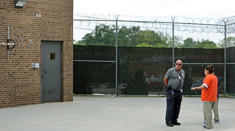 A recreation officer, center, talks with female detainees in the recreation yard of the North Georgia Detention Center in Gainesville, Ga., on May 16, 2013. These detainees are immigrants that face deportation. The center is one of a several of its kind in Georgia.