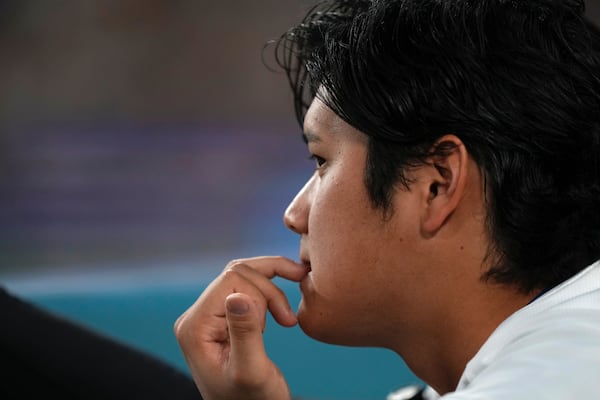Los Angeles Dodgers' Shohei Ohtani watches from the dugout during the fourth inning of a baseball game against the Milwaukee Brewers, Friday, July 18, 2025, in Los Angeles. (AP Photo/Mark J. Terrill)