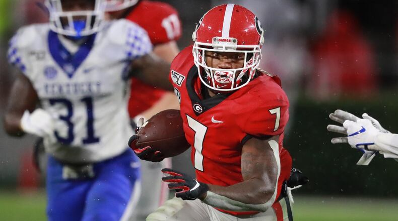 University of Georgia tailback D’Andre Swift picks up yardage against Kentucky in an NCAA college football game Saturday in Athens. State Rep. Billy Mitchell, D-Stone Mountain, is proposing a bill modeled on similar legislation in California that would allow college athletes to be paid. Curtis Compton/ccompton@ajc.com