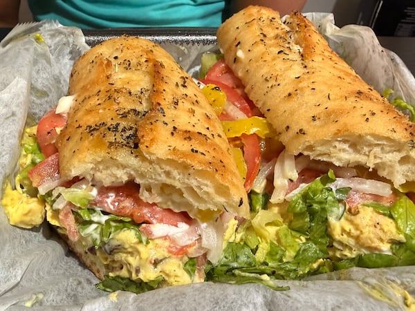 A large Italian sandwich wrapped in paper.
