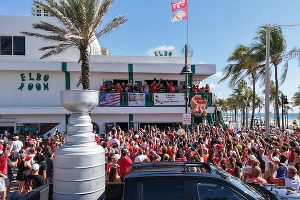 Members of the Florida Panthers hockey team celebrate with fans outside the Elbo Room, Wednesday, June 18, 2025, in Fort Lauderdale, Fla., the morning after defeating Edmonton in Game 6 of the Stanley Cup Final. (Amy Beth Bennett/South Florida Sun-Sentinel via AP)