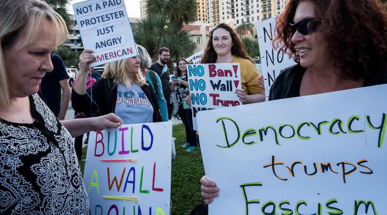 Protesters meet in front of Trump Plaza in West Palm Beach as President Donald Trump and his wife Melania attend the 60th annual Red Cross Ball at the Mar-a-Lago on Saturday Feb. 4, 2017. Michael Ares / Daily News