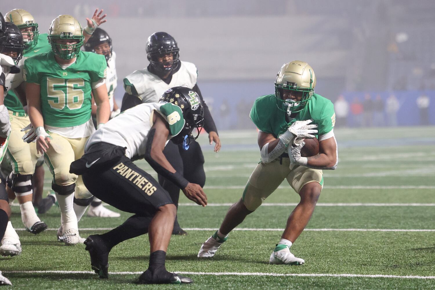 Buford running back CJ Clinkscales (5) scores a touchdown against Langston Hughes defensive back Rodney Shelley (6) during the first half of the Class 6A state title football game at Georgia State Center Parc Stadium Friday, December 10, 2021, Atlanta. JASON GETZ FOR THE ATLANTA JOURNAL-CONSTITUTION