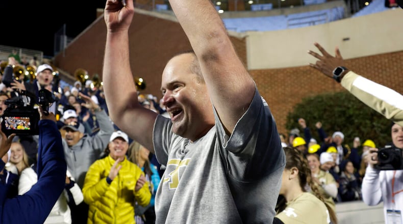 Georgia Tech interim coach Brent Key celebrates with fans after the team defeated North Carolina on Saturday in Chapel Hill, N.C. (AP Photo/Chris Seward)